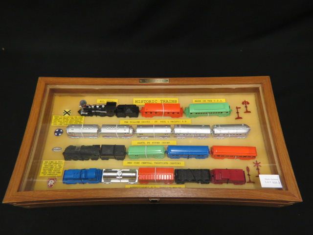 Appraisal: Midgetoy Metal Toy Trains display set in glass top case