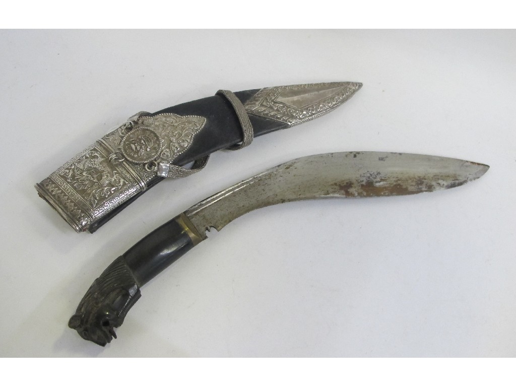 Appraisal: White metal mounted kukri with animal head hilt