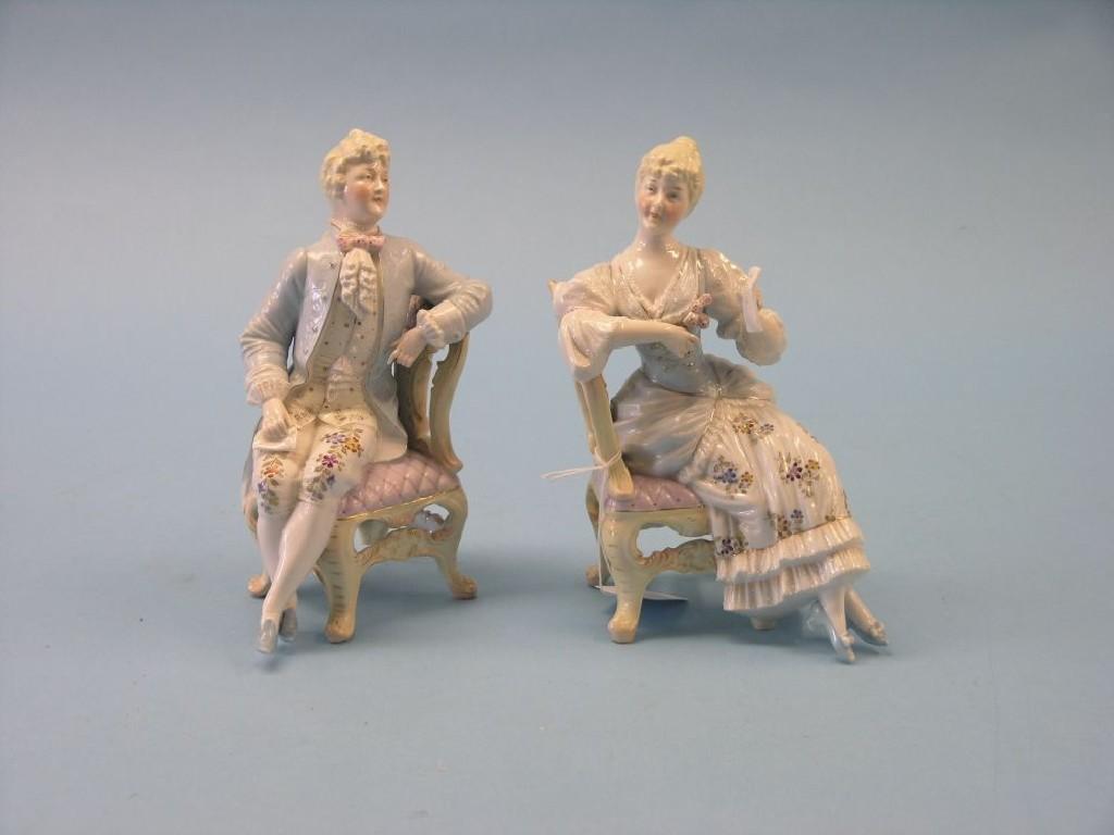 Appraisal: A pair of late th century German porcelain seated figures