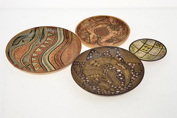 Appraisal: A GROUP OF FOUR CARL COOPER ABORIGINAL THEMED DISHES