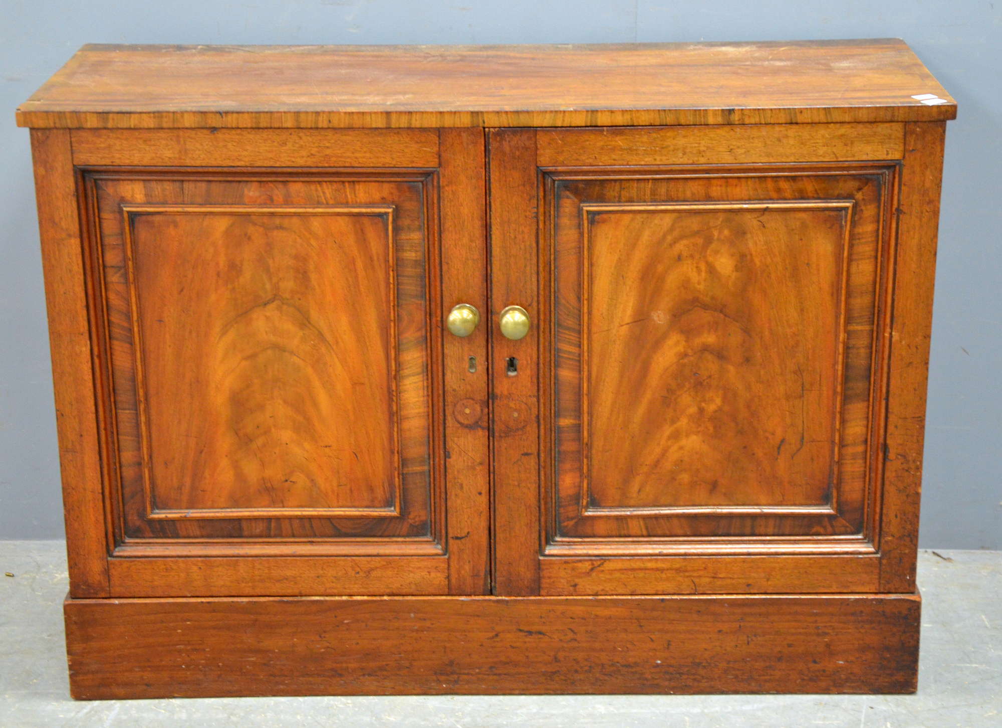 Appraisal: th century mahogany and cross banded two door cabinet enclosing