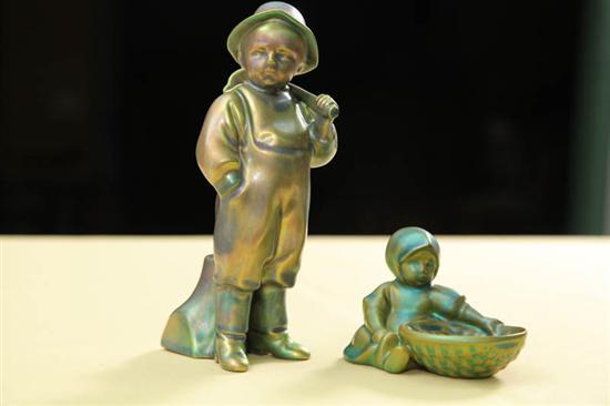 Appraisal: TWO ZSOLNAY FIGURES A boy with a water pitcher h