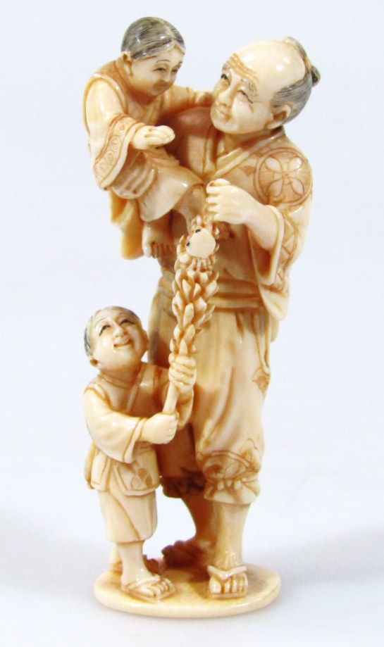 Appraisal: A late thC Japanese ivory figure group of a gentleman