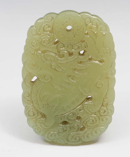 Appraisal: A Chinese yellowish green jade pendant th Centurycarved and pierced