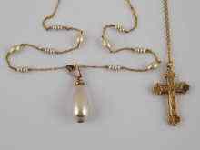 Appraisal: A yellow metal tests carat gold cross and chain approx