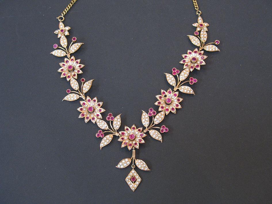 Appraisal: AN INDIAN PEARL AND RUBY-SET NECKLACE formed as flowerheads and