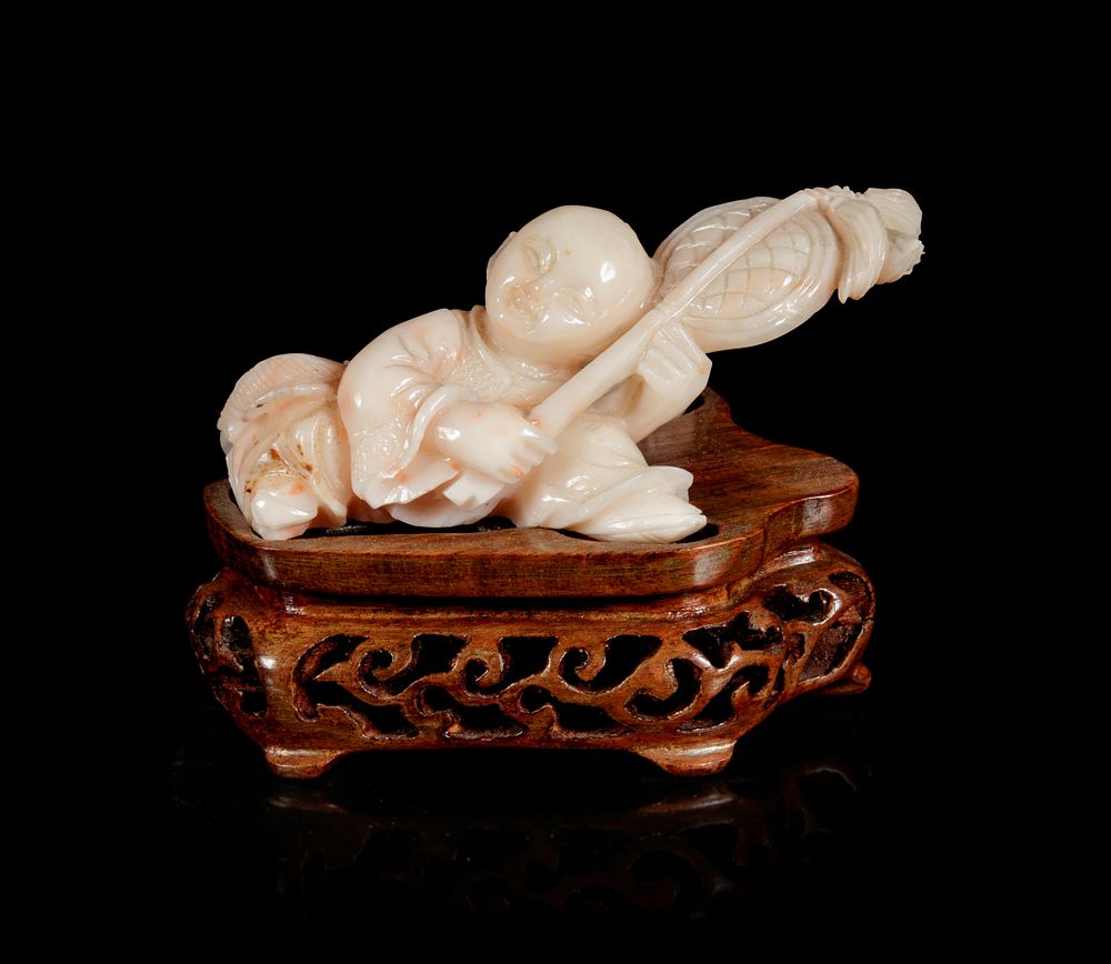 Appraisal: A Pink Coral Carving of a Boy Width in cm