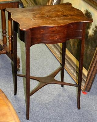 Appraisal: A Regency mahogany worktable with serpentine border and platform base