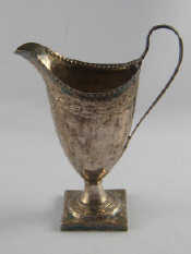 Appraisal: A Georgian silver helmet shaped cream jug on square base