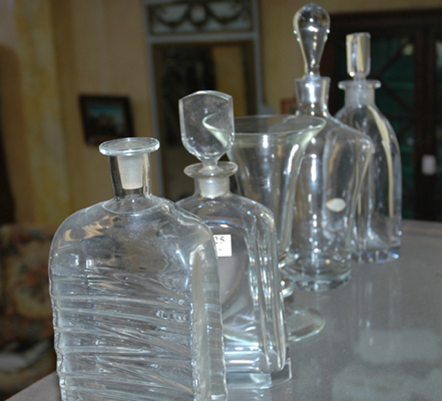 Appraisal: THREE CRYSTAL DECANTERS AND A VASE Including two faceted Orrefors