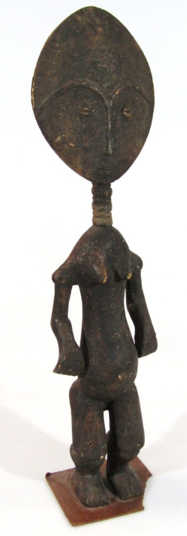 Appraisal: A thC carved African tribal figure with oval face entwined