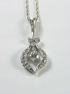 Appraisal: PENDANT - A white gold drop style pendant centered by