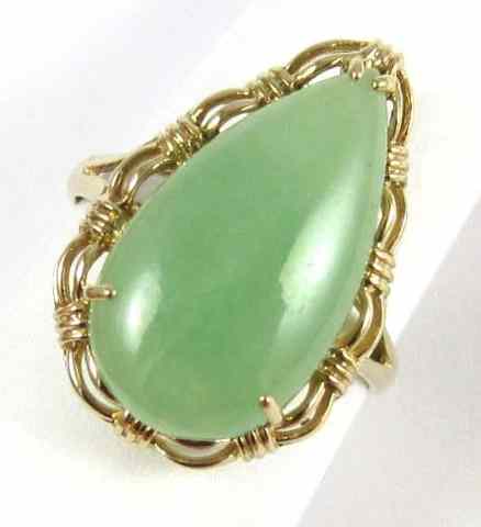 Appraisal: JADE AND FOURTEEN KARAT GOLD RING set with a pear