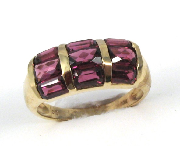 Appraisal: PURPLE GEMSTONE AND YELLOW GOLD RING set with nine facet-cut