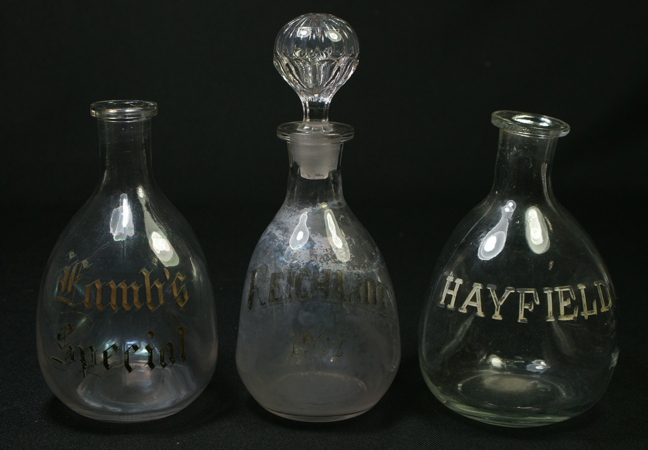 Appraisal: clear glass back bar pinch bottles with gilt etched decoration