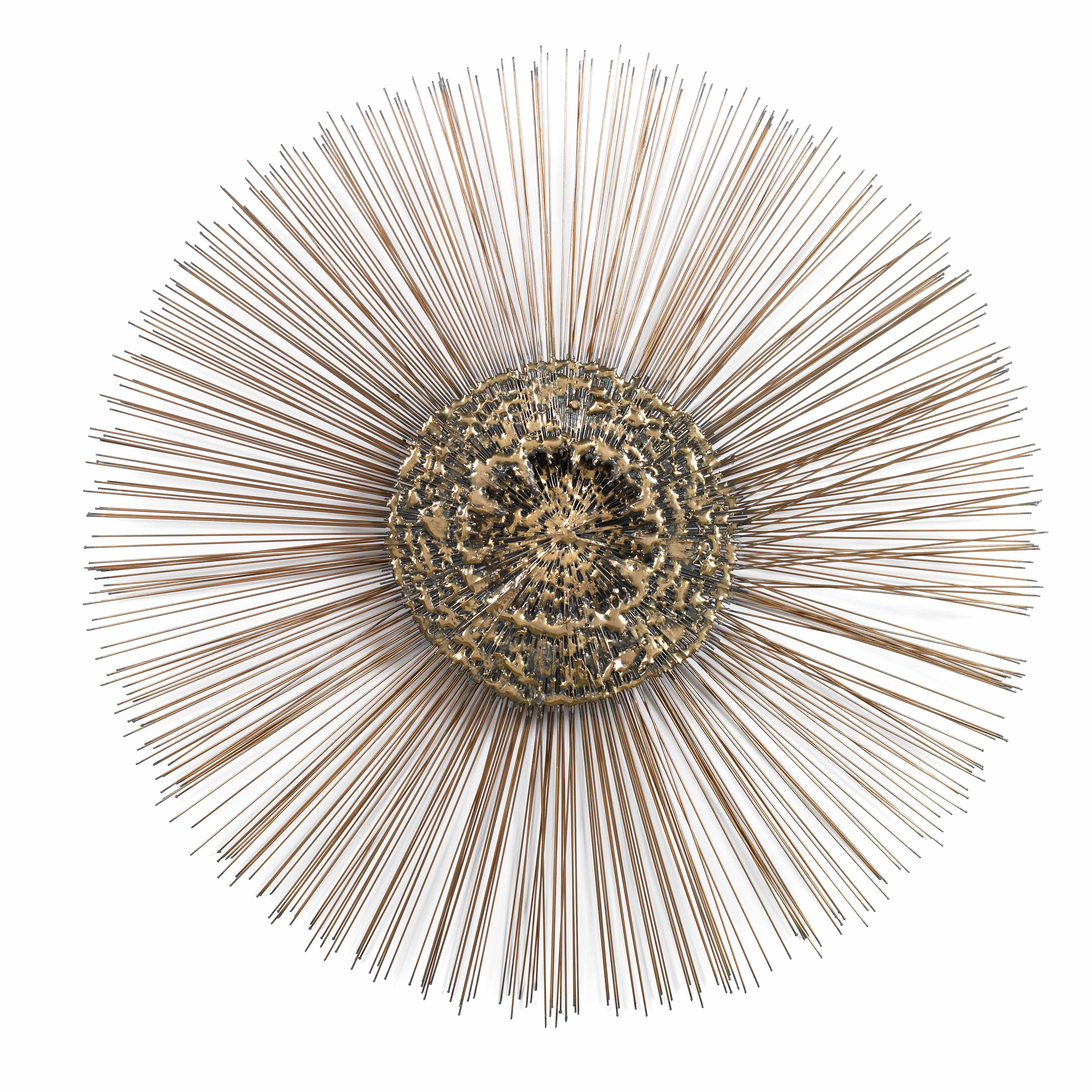 Appraisal: A gilt and patinated metal wall sunburst sculpture in the