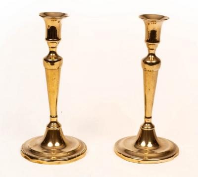 Appraisal: A pair of late th Century silver plated brass candlesticks