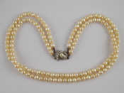 Appraisal: A two row cultured pearl necklace with a yellow and