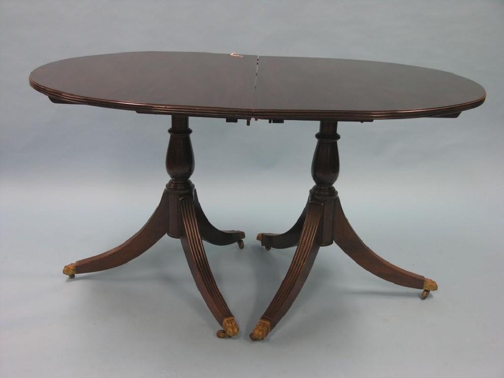 Appraisal: A Georgian-style mahogany D-end dining table on twin-pedestal supports with