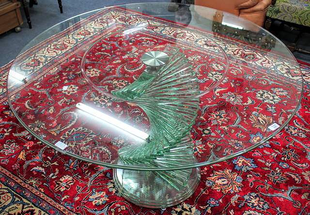 Appraisal: A CONTEMPORARY GLASS CIRCULAR TOPPED TABLE with a twisted stepped