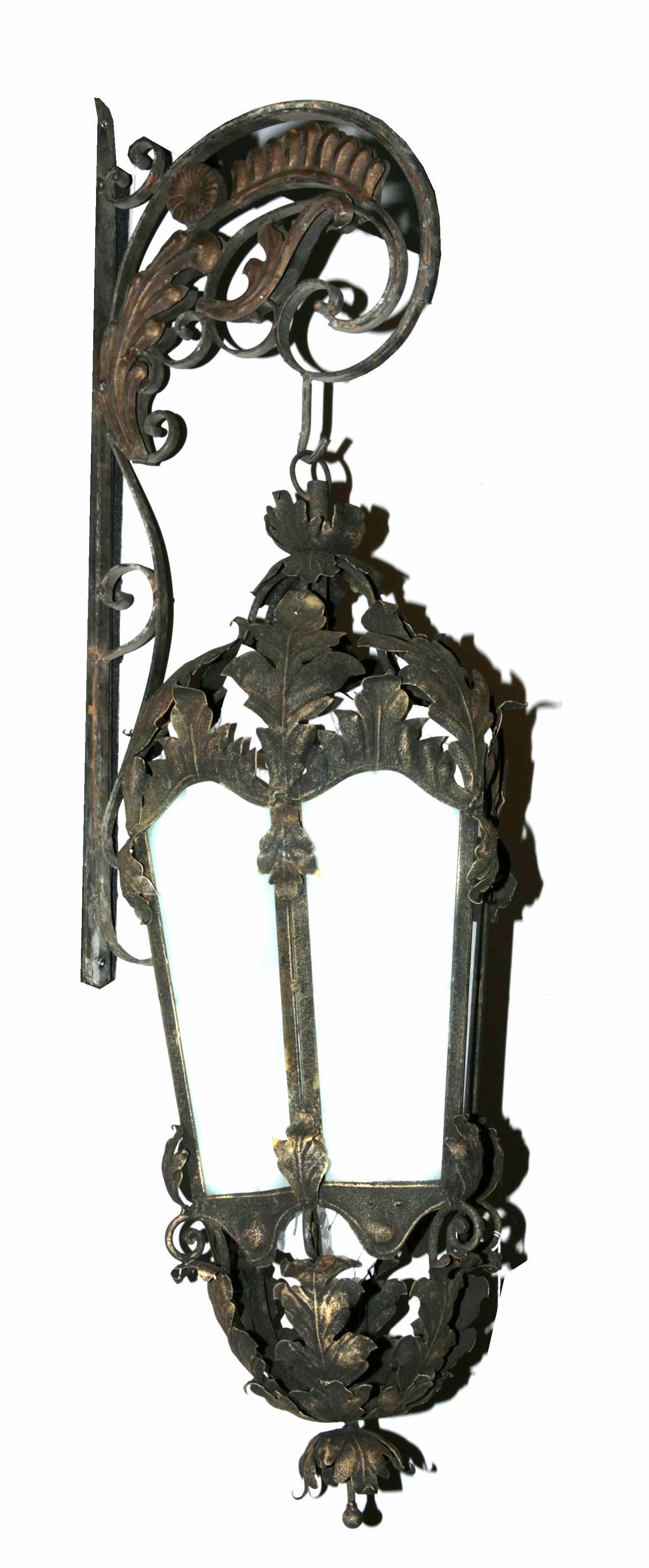 Appraisal: A pair of Rococo style wrought iron and tle lanterns