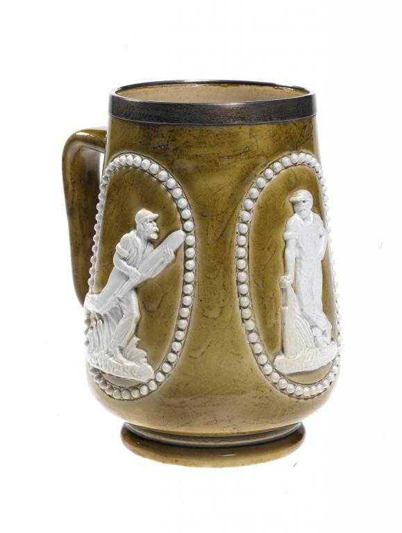 Appraisal: CRICKET A SILVER-MOUNTED DOULTON WARE MUG applied with three reliefs