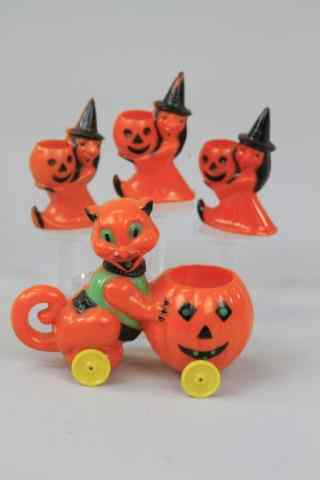 Appraisal: FOUR HARD PLASTIC HALLOWEEN TOYS Cat pushing jack-o-lantern and three