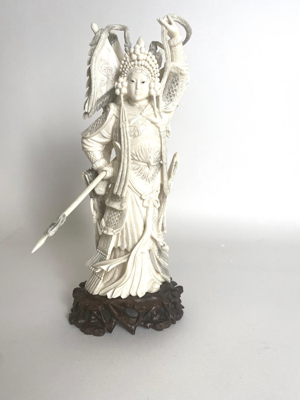 Appraisal: CHINESE CARVING OF A FEMALE WARRIOR DEITYUnsigned Elaborately carved the