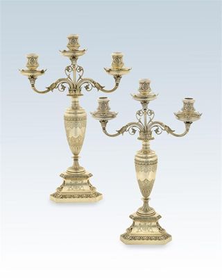 Appraisal: A pair of Victorian three light candelabra on triform bases