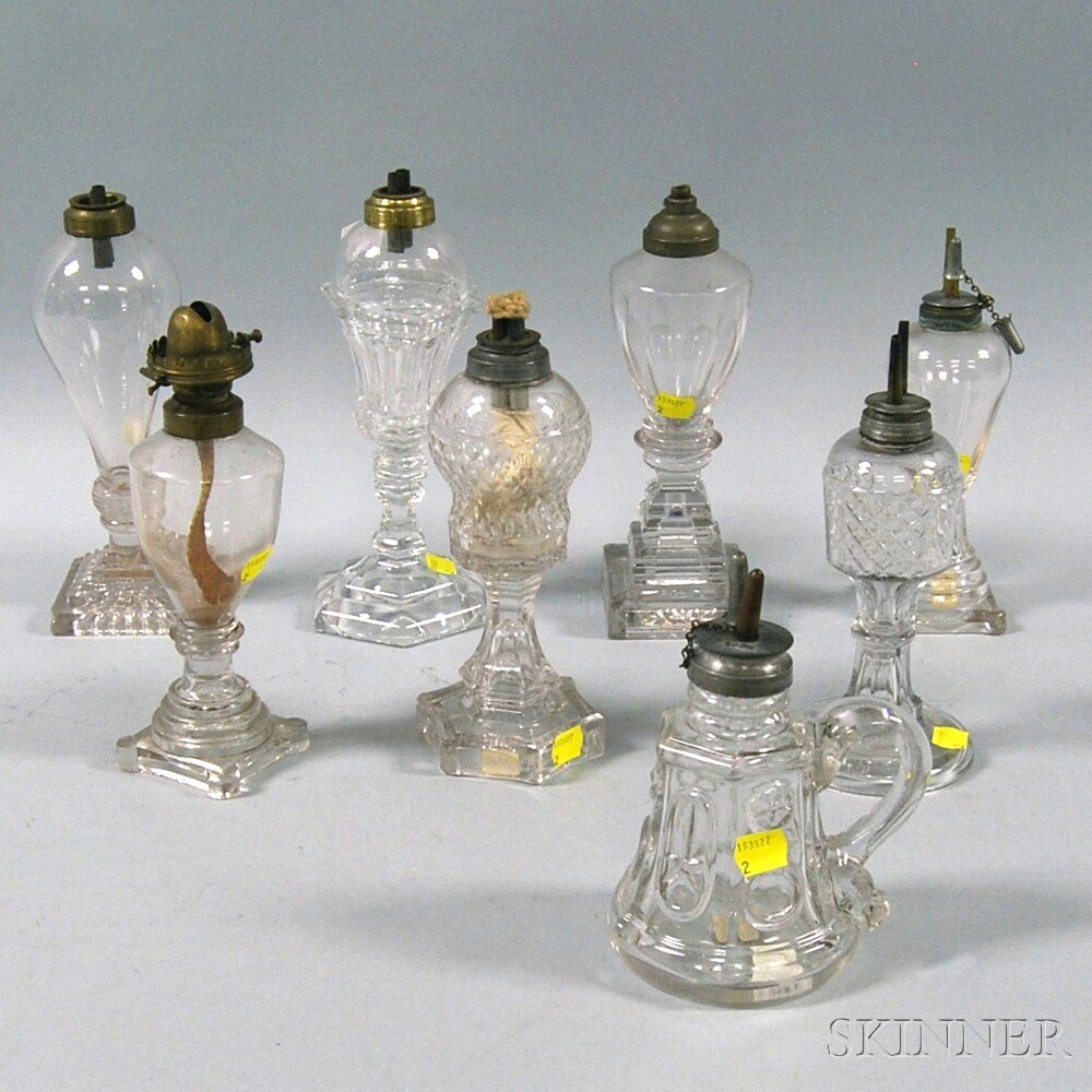 Appraisal: Eight Colorless Pressed Glass Fluid Lamps th century including an