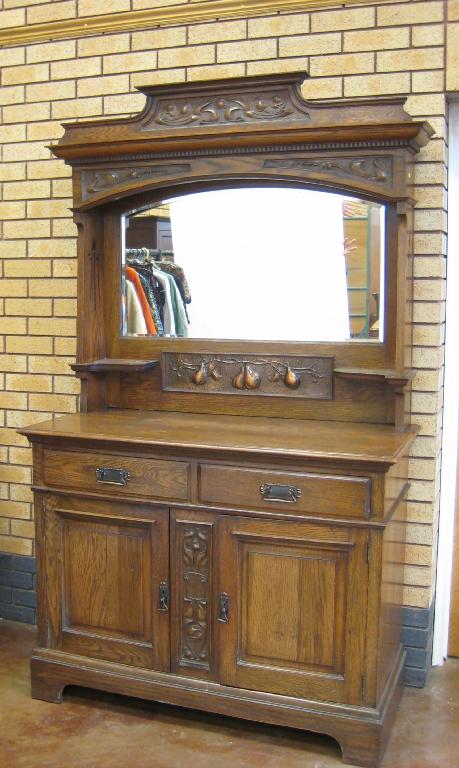 Appraisal: An Arts and Crafts Liberty style oak Mirror back Sideboard