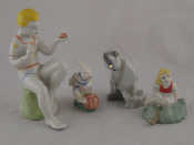 Appraisal: Four Russian ceramic figures being a seated boy holding a