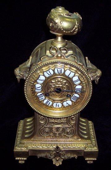 Appraisal: A late th Century gilt brass mantel clock with urn