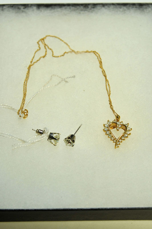 Appraisal: TWO PIECES OF JEWELRY A gold necklace with diamond heart