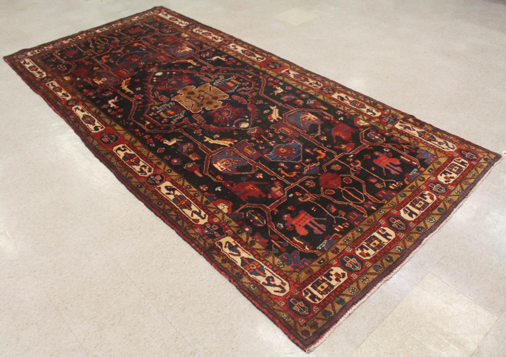 Appraisal: SEMI-ANTIQUE PERSIAN TRIBAL RUG central medallion curvilinear stylized bird and