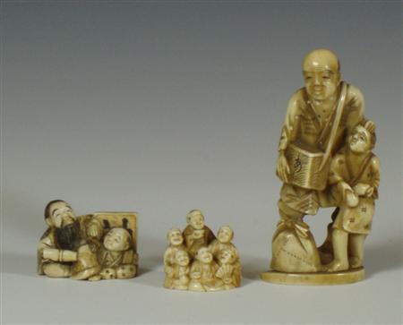 Appraisal: A Japanese ivory okimono of a man with a boy