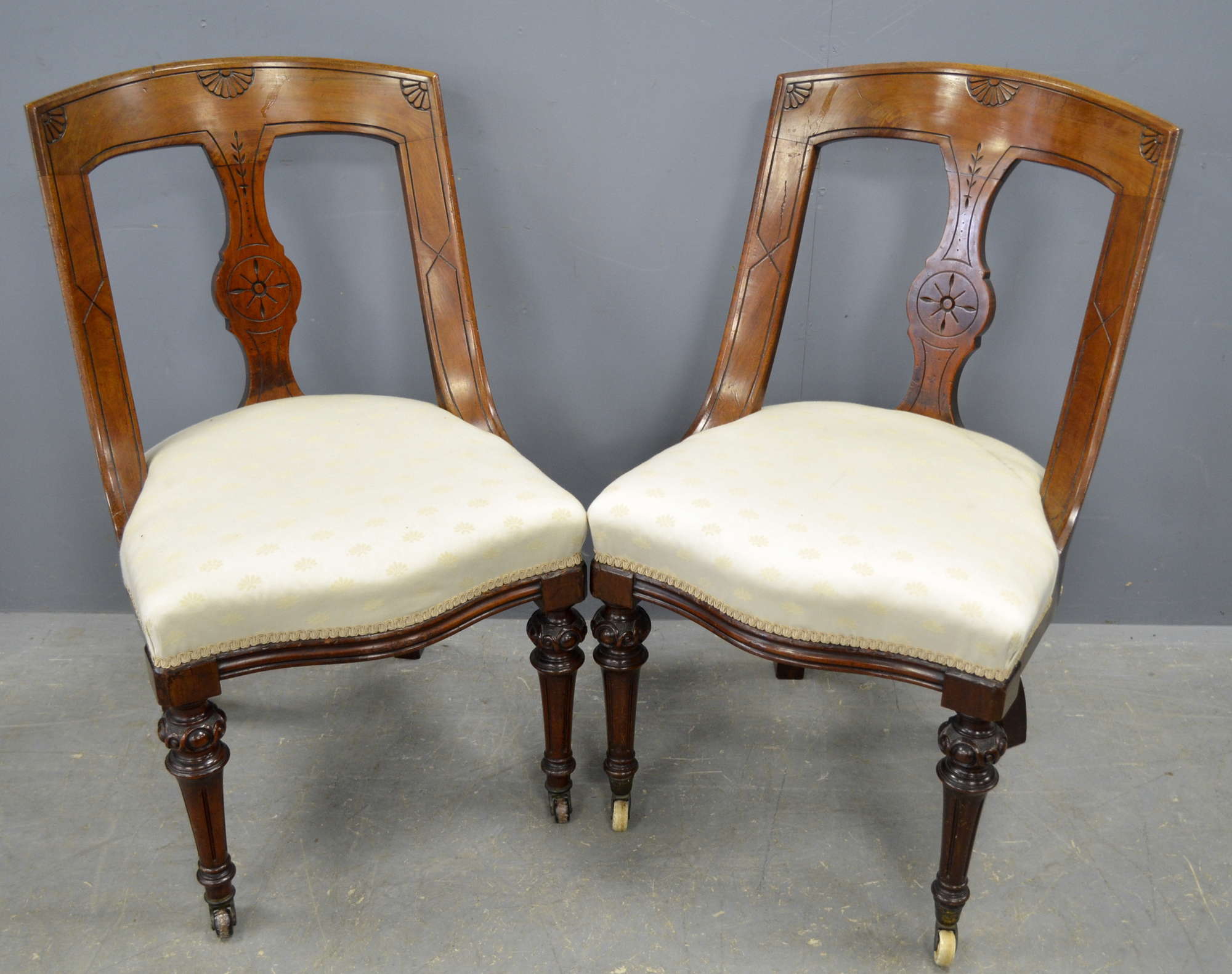 Appraisal: Pair of early th century walnut framed chairs on castors