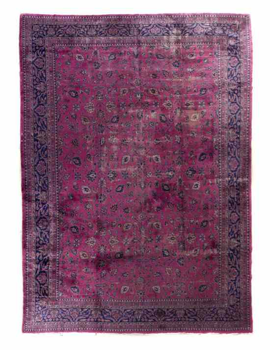 Appraisal: A Sarouk Wool Rug having allover foliate decoration on a