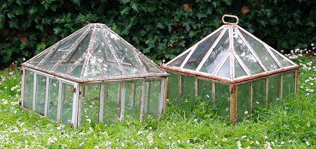 Appraisal: A GROUP OF THREE CAST IRON CLOCHES with pyramidal covers