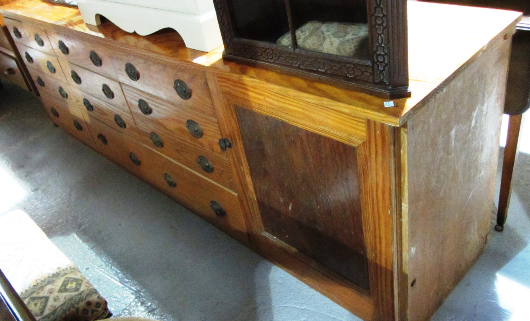 Appraisal: A th century pitch pine sideboard with twelve drawers and