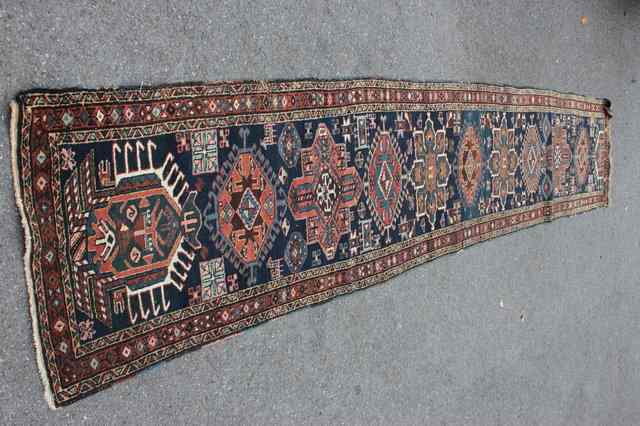 Appraisal: AN HEREZ BLUE GROUND RUNNER decorated hooked and foliate medallions