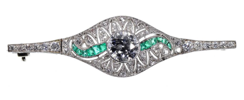 Appraisal: AN EMERALD AND DIAMOND BAR BROOCH with larger central round