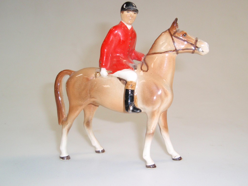 Appraisal: A Beswick style figure of a huntsman on horseback cm