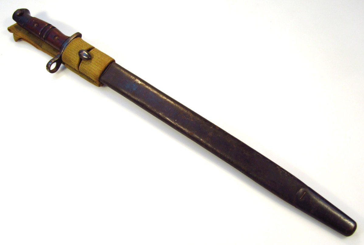 Appraisal: A Remington model bayonet with shaped blade scabbard with material