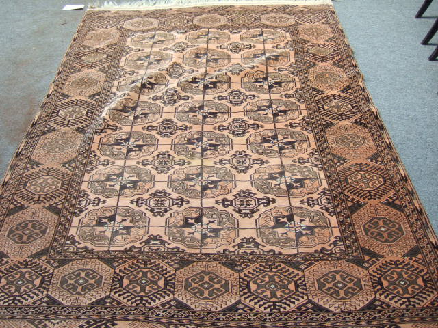 Appraisal: A washed Afghan rug the pale madder field with three