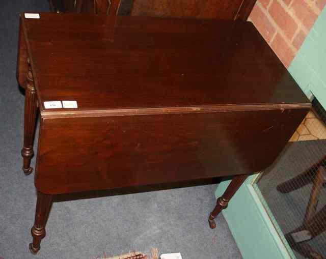 Appraisal: A MAHOGANY PEMBROKE TABLE the top with rounded flaps frieze