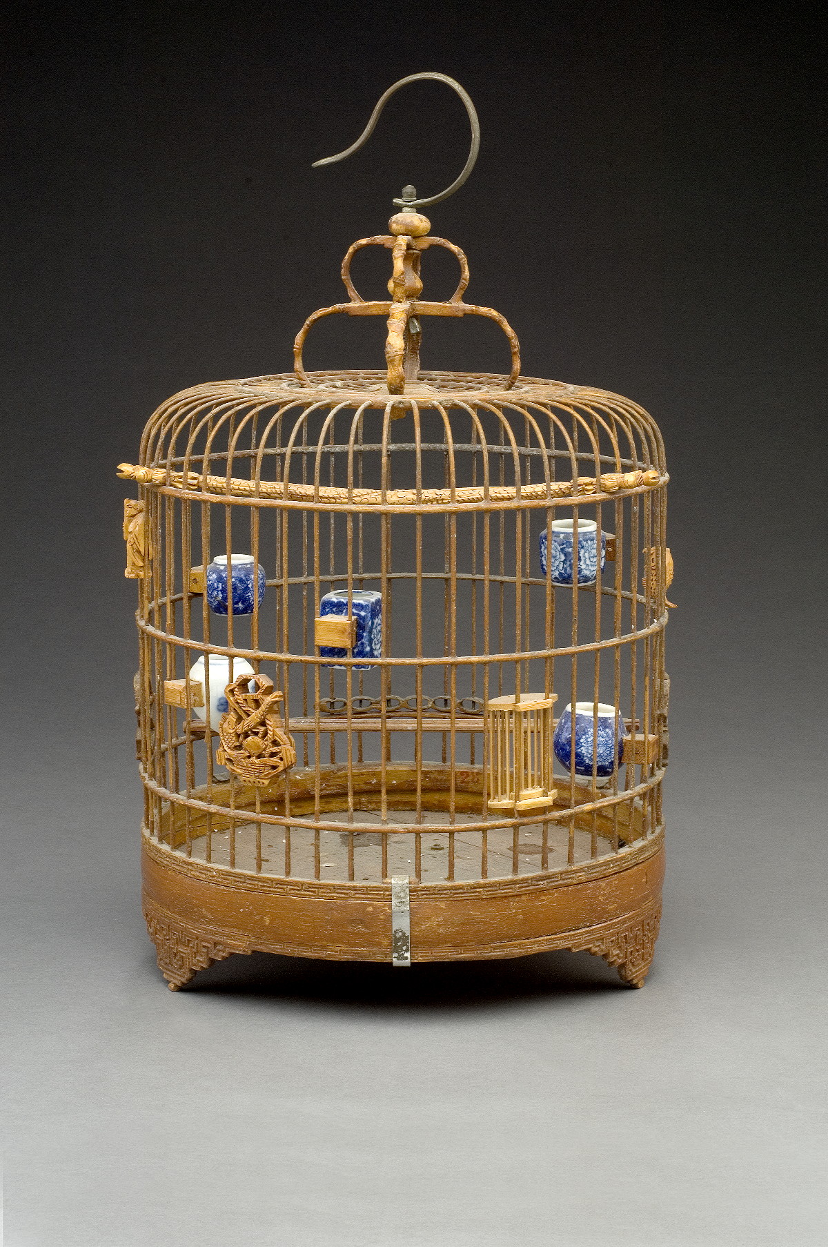 Appraisal: CHINESE RED PAINTED AND CARVED WOOD BIRDCAGE The four feet