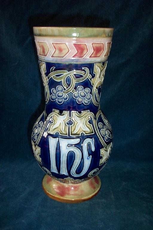 Appraisal: A blue ground Royal Doulton vase with relief moulded ecclesiastical