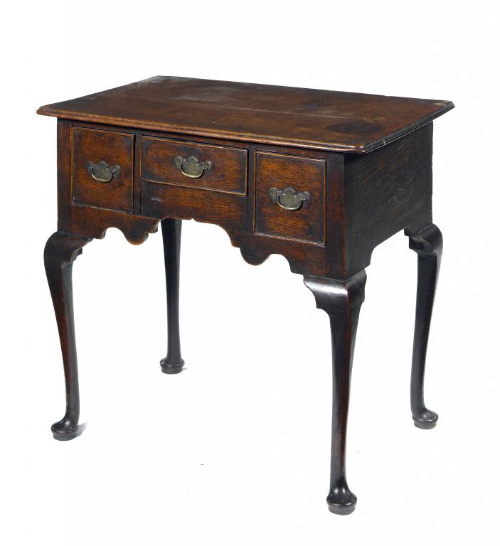 Appraisal: A GEORGE III OAK LOWBOY the ogee arched apron fitted