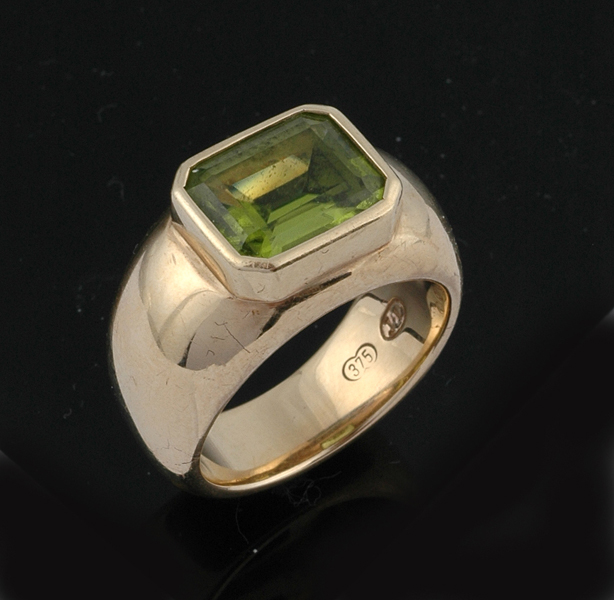 Appraisal: A peridot ring by Jan Logan The wide ct gold